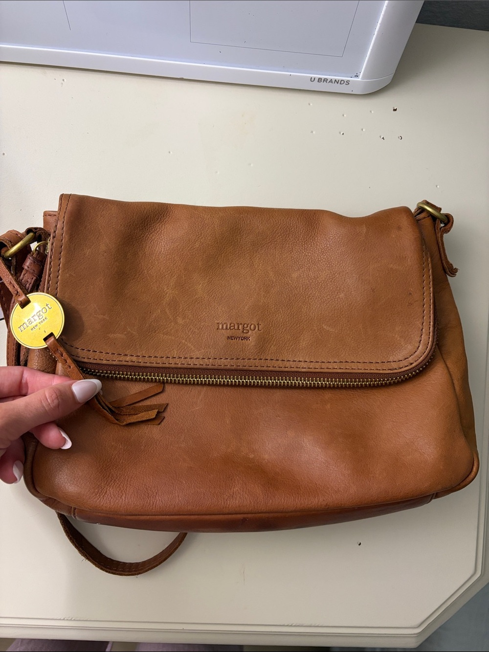 margot tan leather crossbody with tassel zipper pull